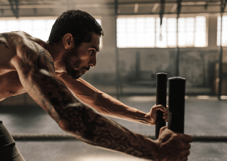 Man exercising with punching bags in a gym setting