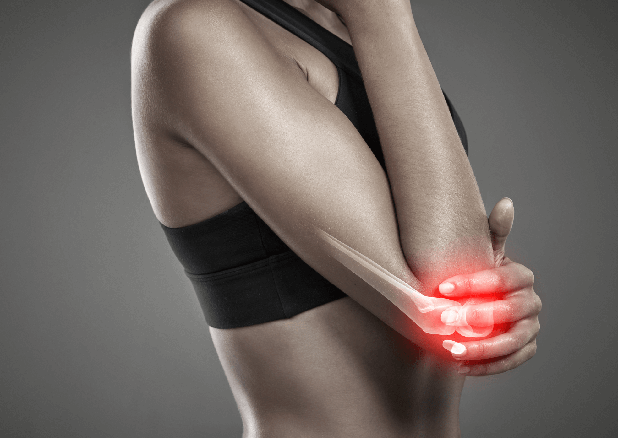 Person holding their arm with a red glow indicating pain on a gray background