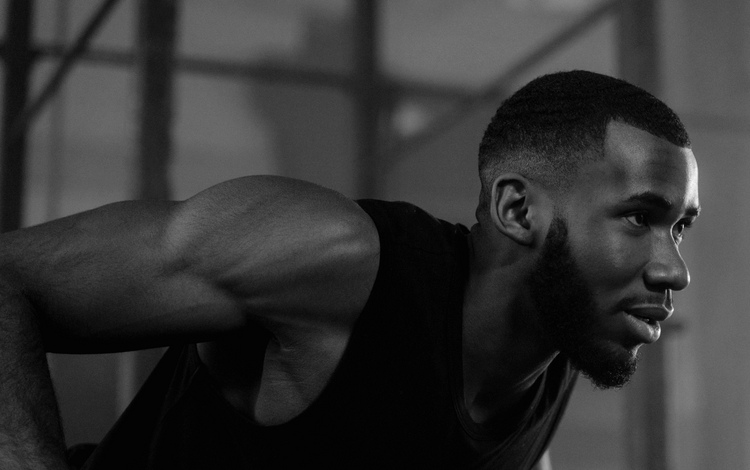 Black and white photo of a man in a gym setting