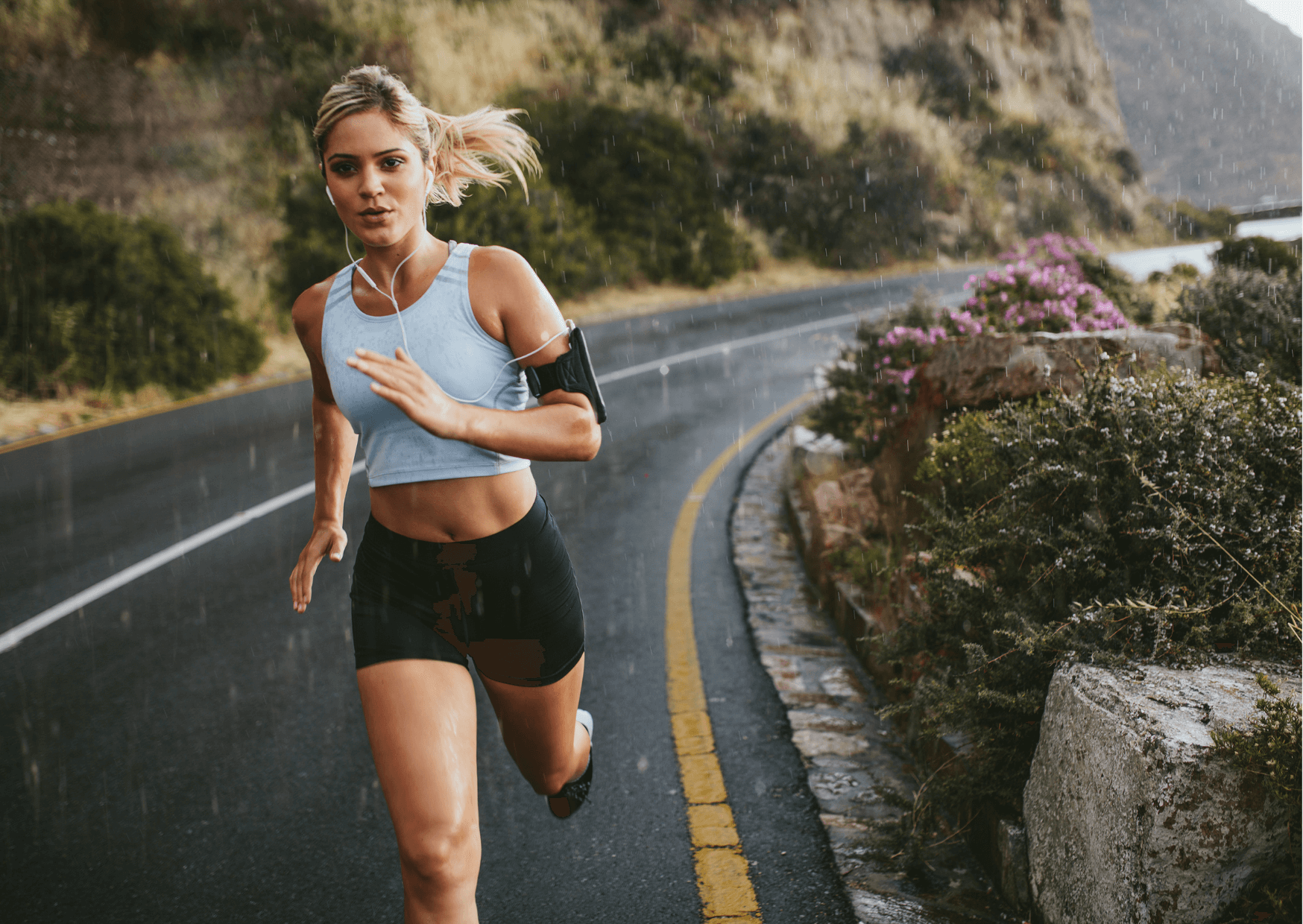 Woman running on a road with a scenic background